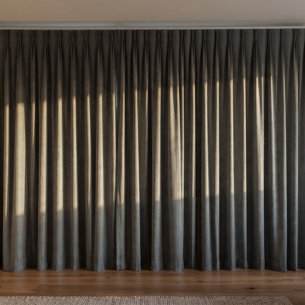 Breakaway Blockout Curtain in Carbon, twin pleat on a ceiling track