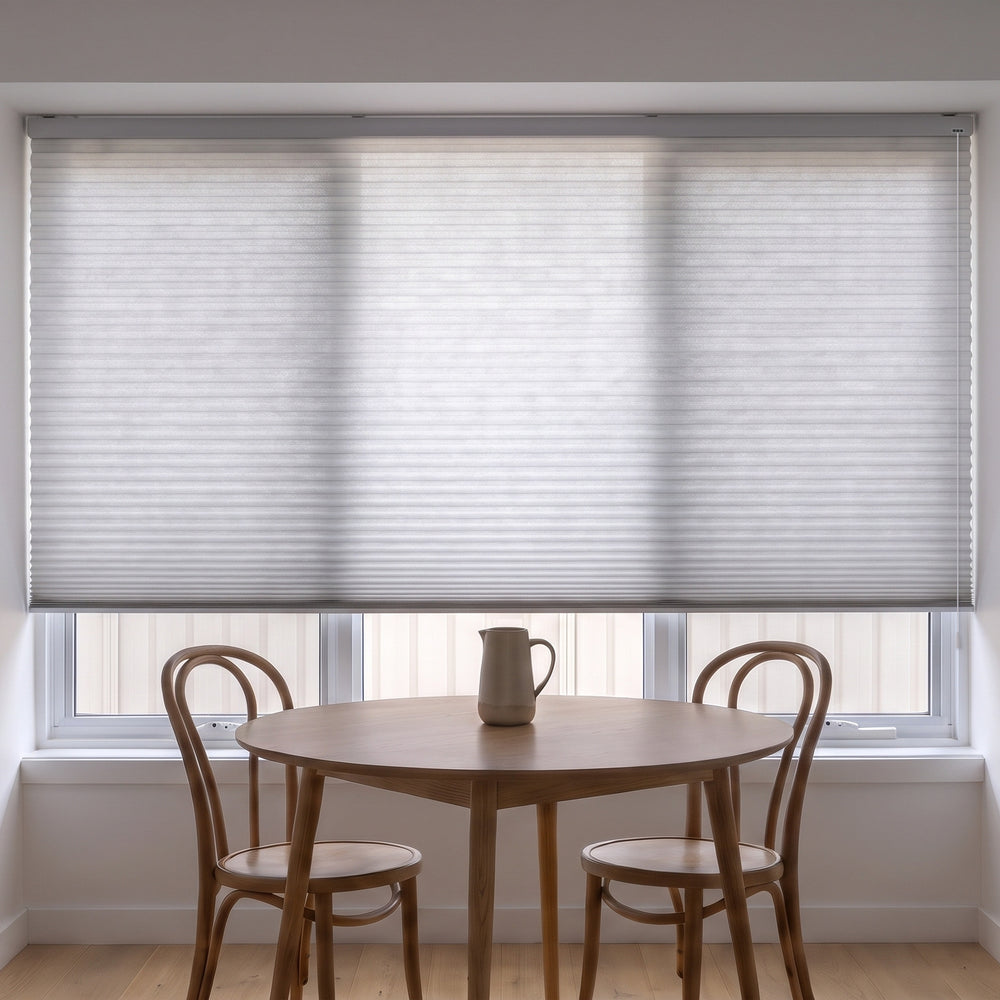 Honeycomb Light Filtering Corded Blind in Grey Sheen, recess fitted in a kitchen dining nook window