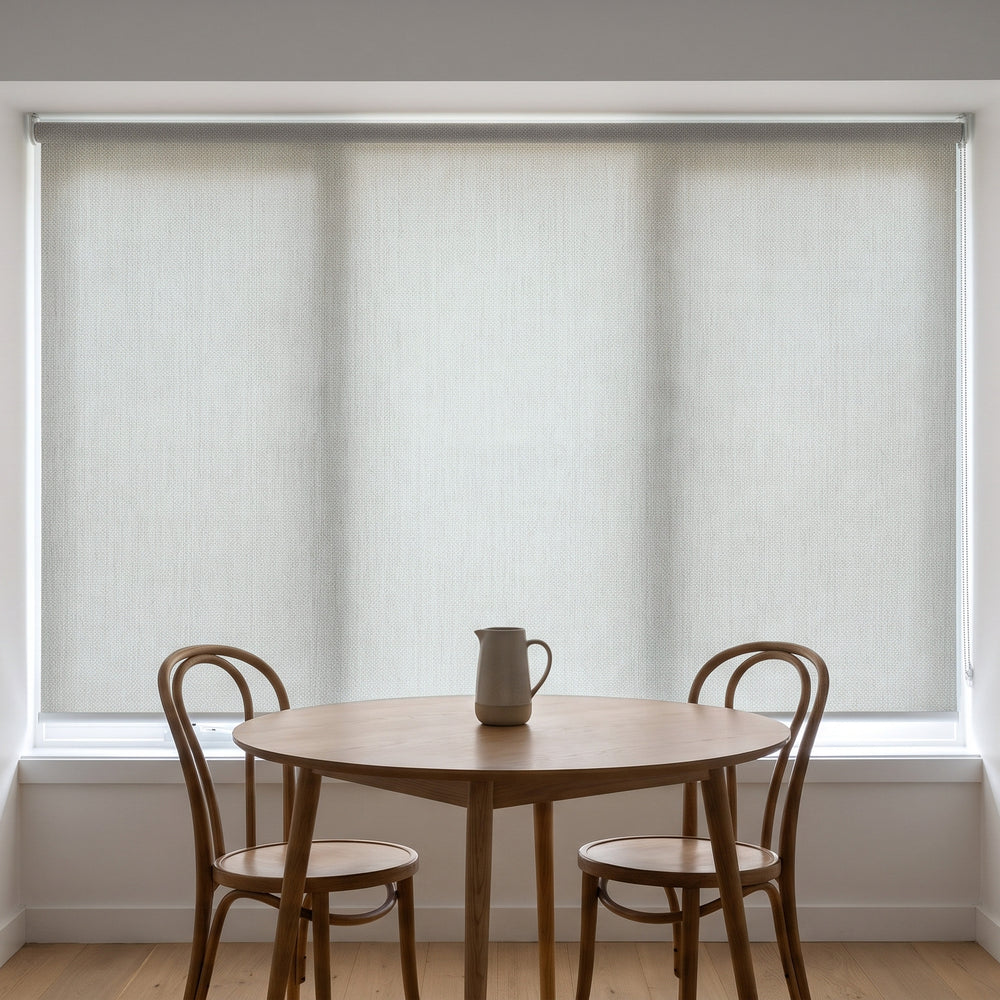 Jersey Light Filtering Roller Blind in Ashen, recess fitted in a kitchen nook window
